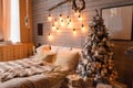 Cosy bedroom with eco decor. Wood and nature concept in interior of room. Scandinavian interior with christmas tree, real photo. H Royalty Free Stock Photo