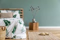 Cosy, boho bedroom interior with wooden bed. Royalty Free Stock Photo
