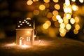 A little house with stars on the snow in the night with boche background. Royalty Free Stock Photo