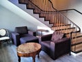 Cosy interior with stairs, chairs and table in hall