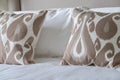 Cosy patterned cushions on a bed