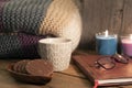 Cosy scene of coffee cup, biscuits, notebook and glasses with wooden background Royalty Free Stock Photo