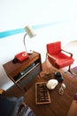 Cosy vintage room with retro radio turntable, telephone, standart lamp, armchair as well and abacus, camera, glasses. Interior of