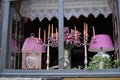 Cosy window with purple lamps, candles and lilies.