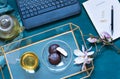 Cosy work space flat lay with magnolia flowers, laptop and green tea with marshmallows. Tea break concept.