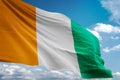 Cote d`Ivoire Ivory coast national flag waving blue sky background realistic 3d illustration