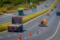 Cotopaxi, ECUADOR - 08 September 2019: Workmen painting lines on road. Road line car painting white lines and central