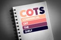COTS - Commercial Off-the-Shelf acronym on notepad, business concept background