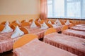 Cots in the kindergarten. Orphanage or boarding school. Beds in a boarding school or in an orphanage Royalty Free Stock Photo