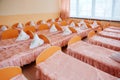 Cots in the kindergarten. Orphanage or boarding school. Beds in a boarding school or in an orphanage Royalty Free Stock Photo