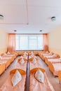 Cots in the kindergarten. Orphanage or boarding school. Beds in a boarding school or in an orphanage Royalty Free Stock Photo