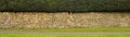 Cotswold stone wall alongside a path - banner Royalty Free Stock Photo