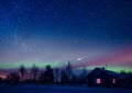 Cottage against the night sky with the Milky Way and the arctic Northern lights Aurora Borealis in snow winter Finland