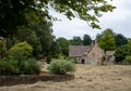 Cottage built of stone facing the green in the village of Wick, also known as Wyck, Rissington, an unspoilt Cotswold village, UK Royalty Free Stock Photo