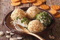 Cottage cheese balls with crackers, herbs and pumpkin seeds close-up. Horizontal