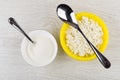 Cottage cheese in bowl, spoon, sugar and teaspoon on table Royalty Free Stock Photo