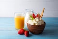 Cottage cheese for Breakfast with strawberries, milk and juice on blue wooden background Royalty Free Stock Photo