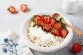 Cottage cheese, curd cheese with strawberries berries in a bowl, ogranic homemade dairy product. Healthy dairy product rich in Royalty Free Stock Photo