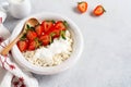 Cottage cheese, curd cheese with strawberries berries in a bowl, ogranic homemade dairy product. Healthy dairy product rich in Royalty Free Stock Photo