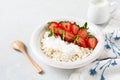 Cottage cheese, curd cheese with strawberries berries in a bowl, ogranic homemade dairy product. Healthy dairy product rich in Royalty Free Stock Photo