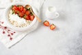 Cottage cheese, curd cheese with strawberries berries in a bowl, ogranic homemade dairy product. Healthy dairy product rich in Royalty Free Stock Photo