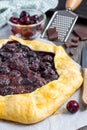 Cottage cheese dough galette with cherries and chocolate, vertical Royalty Free Stock Photo