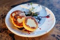 Cottage cheese fritters, curd pancakes or syrniki served with blueberry jam, greek yogurt or sour cream on wooden table Royalty Free Stock Photo