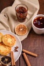 Cottage cheese fritters with hot black aromatic tea with fig jam, Christmas breakfast mood with anise, cinnamon Royalty Free Stock Photo