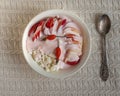 Cottage cheese with fruit and sour cream in a white deep plate