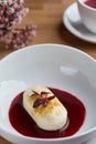 Cottage cheese pancakes with berry sauce on wooden table close up. morning table. breakfast concept Royalty Free Stock Photo