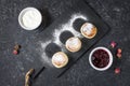 Cottage cheese pancakes on black stone background. Syrniki with sour cream. Homemade food