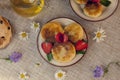 Cottage cheese pancakes, curd fritters with fresh berries strawberries with daisy flowers Royalty Free Stock Photo