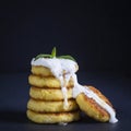 Cottage cheese pancakes with raisins, sour cream, honey, syrniki on black background Royalty Free Stock Photo