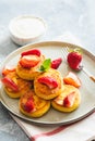 Cottage cheese pancakes, ricotta fritters or syrniki with mint and strawberries. Healthy and delicious morning breakfast Royalty Free Stock Photo