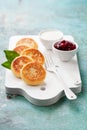 Cottage cheese pancakes Russian syrniki with cranberry jam and yogurt Royalty Free Stock Photo