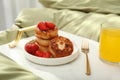 Cottage cheese pancakes with strawberries and honey served on white bed tray Royalty Free Stock Photo