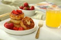 Cottage cheese pancakes with strawberries and honey served on white bed tray Royalty Free Stock Photo