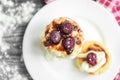 Cottage cheese pancakes with strawberry jam on white plate on grey wooden background. Healthy breakfast Royalty Free Stock Photo