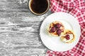 Cottage cheese pancakes with strawberry jam on white plate on grey wooden background. Healthy breakfast Royalty Free Stock Photo
