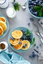 Cottage cheese pancakes, sweet curd fritters with berries, syrniki with honey and fresh blueberry Royalty Free Stock Photo