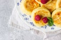 Cottage cheese pancakes, syrniki, curd fritters with honey, raspberry and mint. Gourmet breakfast.