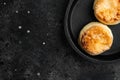 Cottage cheese pancakes, syrniki, ricotta fritters  on cast iron frying pan skillet on cast iron frying pan skillet, top view flat Royalty Free Stock Photo