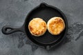 Cottage cheese pancakes, syrniki, ricotta fritters  on cast iron frying pan skillet on cast iron frying pan skillet, top view flat Royalty Free Stock Photo