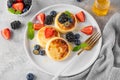 Cottage cheese pancakes, syrniki, ricotta fritters with fresh berries, honey and sour cream on a gray concrete background. Healthy Royalty Free Stock Photo