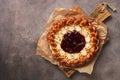 Cottage cheese pie with strawberry jam on a wooden cutting board, dark rustic background. Top view, flat lay, copy space Royalty Free Stock Photo