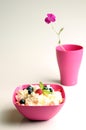 Cottage cheese in pink plastic bowl decorated mint and berry. Royalty Free Stock Photo