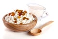 Cottage cheese with raisins and sour cream in a wooden bowl isolated on a white background Royalty Free Stock Photo