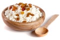 Cottage cheese with raisins in a wooden bowl isolated on a white background Royalty Free Stock Photo