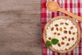 Cottage cheese with raisins in a wooden bowl on old wooden background with copy space for your text. Top view Royalty Free Stock Photo