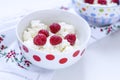 Cottage cheese with raspberry in white bowl of peas
